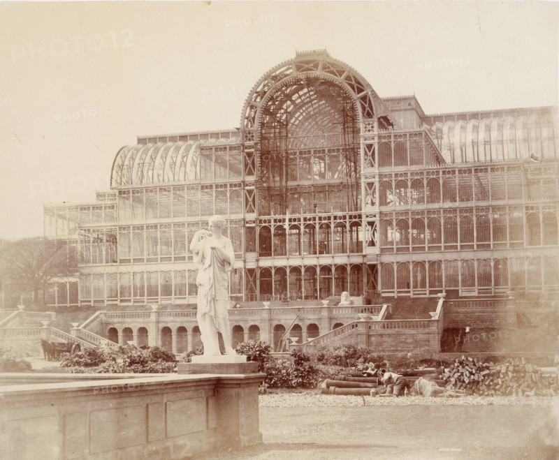 'The South Transept, from the Second Terrace', Crystal Palace, Sydenham, 1852-1854. Designed by Sir Joseph Paxton to house the Great Exhibition of 1851 in Hyde Park, the Crystal Palace was reconstructed and enlarged in Sydenham in 1852. The first column was raised on 5 August 1852 and the palace was opened by Queen Victoria on 10 June 1854. Many exhibitions and events were subsequently held at the Crystal Palace until it burnt down on 30 November 1936. The park contained a motor racing circuit from 1937 until 1972 and the famous athletics track dates back to the foundation of the Crystal Palace Athletics Club in 1868. Plate 59 from "Photographic Views of the Progress of the Crystal Palace, Sydenham. Taken during the progress of the works, by desire of the directors, by Philip H Delamotte. Together with a list of the directors and officers of the company, etc". [London, 1855].