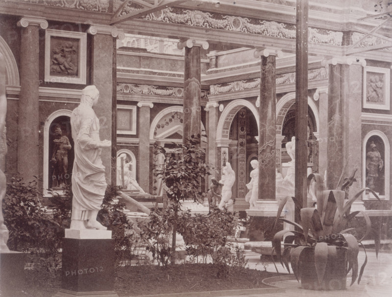 'Exterior of the Italian Court', Crystal Palace, Sydenham, 1852-1854. Designed by Sir Joseph Paxton to house the Great Exhibition of 1851 in Hyde Park, the Crystal Palace was reconstructed and enlarged in Sydenham in 1852. The first column was raised on 5 August 1852 and the palace was opened by Queen Victoria on 10 June 1854. Many exhibitions and events were subsequently held at the Crystal Palace until it burnt down on 30 November 1936. The park contained a motor racing circuit from 1937 until 1972 and the famous athletics track dates back to the foundation of the Crystal Palace Athletics Club in 1868. Plate 84 from "Photographic Views of the Progress of the Crystal Palace, Sydenham. Taken during the progress of the works, by desire of the directors, by Philip H Delamotte. Together with a list of the directors and officers of the company, etc". [London, 1855].