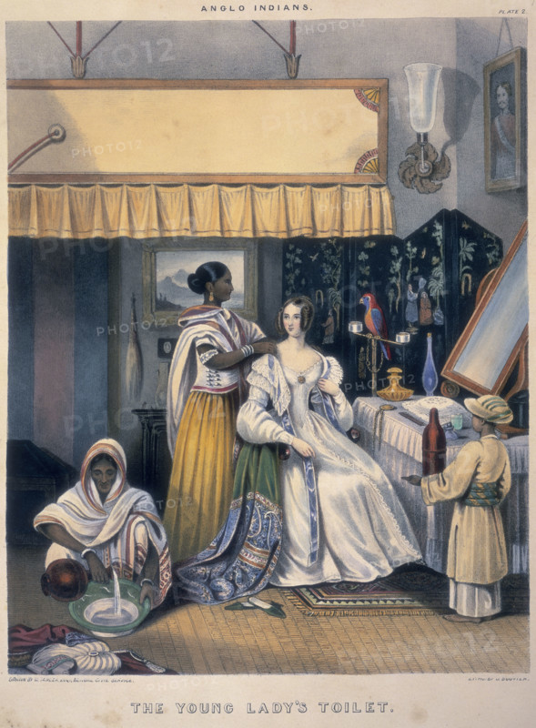 'The Young Lady's Toilet', 1842. A European woman, probably the wife or daughter of an official in the British Raj in India, is attended by Indian servants. One helps her dress, another pours water into a bowl, and a small boy stands holding a bottle. The title above, 'Anglo Indians', probably refers to British people living in India, rather than people of mixed Indian and English descent. From "Sketches illustrating the Manners and Customs of Indians & Anglo Indians".