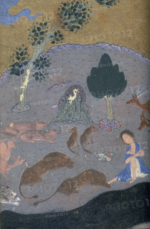 Majnun in the desert with the animals, c1410-c1411. Majnun sits in the desert surrounded by a stag, a leopard, and wolves. A scene from the love story of Majnun and Layla.