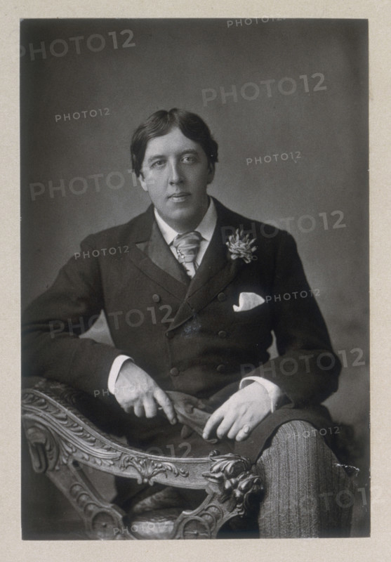 Oscar Wilde, c1890-c1894. Irish poet, author, dramatist, and exponent of "art for art's sake". His best known novel is "The Picture of Dorian Gray". He wrote a book of children's stories "The House of Pomegranates", and a series of plays including "Lady Windermere's Fan", "A Woman of No Importance", and "The Importance of Being Ernest", believed by many to be the first modern comedy in English. Wilde was convicted of sodomy over his relationship with Lord Alfred Douglas in a notorious trial, and was jailed at Reading from 1895-1897. After his release he moved to Paris and wrote "The Ballad of Reading Gaol", protesting at the inhumane conditions in prisons at the time. He died suddenly in 1900 from meningitis.