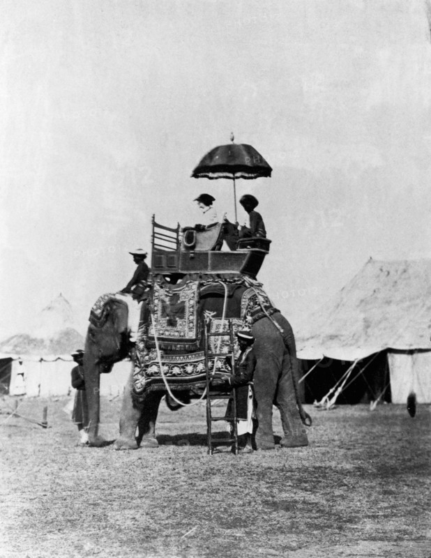 Lady Canning 'going out to sketch', c1861. Lady Canning, wife of the Governor-General of India, sitting in howdah, shielded by a parasol held by the servant seated behind her. Another servant holds a ladder for mounting and dismounting from the elephant. From Camp - "The Story of Two Noble Lives" (about Countess Canning and the Marchioness of Waterford, sisters and artists).