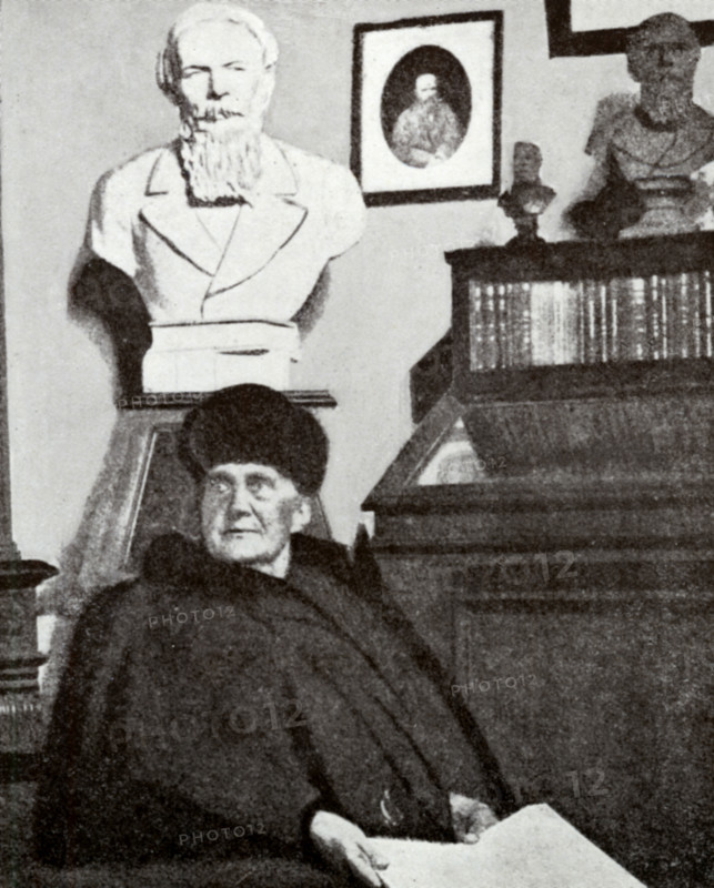 Mme Dostoevsky at work in the Dostoevsky room of the Moscow Historical Museum (taken during her last visit there), 1916. Anna Dostoyevskaya (1846-1918) was a Russian writer, philatelist, memoirist and stenographer in her own right, as well as assistant and wife of Fyodor Mikhaylovich Dostoyevsky. She was also one of the first female philatelists in Russia. Behind her are portrait busts of her husband. From "Dostoevsky Portrayed by his Wife" by Mme Dostoevsky. Translated from the Russian and edited by S S Koteliansky. [London, 1926].