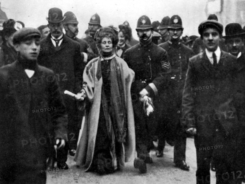 Arrest of Emmeline Pankhurst, London, 13 February 1908. Suffrage campaigner Emmeline Pankhurst was charged with obstructing a policeman while on a deputation to the House of Commons. The next day she received a sentence of six weeks in Holloway prison. The deputation to the Commons followed a meeting at Caxton Hall, where the Suffragettes learned that no mention of women's suffrage was to be made in the King's [ie Edward VII's] Speech. Mrs. Pankhurst can be seen here carrying a scroll of paper on which was written the resolution of the meeting. She was also limping, following an injury sustained the previous month (at a Devon by-election) in an altercation with Liberal party supporters. From "The Suffragette Movement. An intimate account of persons and ideals" by E Sylvia Pankhurst [Emmeline's daughter]. [1931].