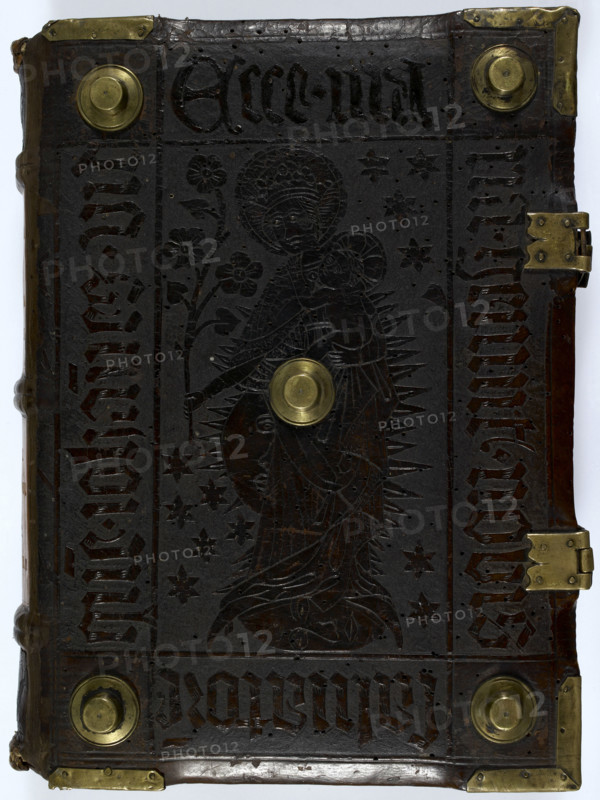 Front cover of "Historia Scholastica", by Petrus Comestor, c1451. Embossed leather cover, with brass studs and corner pieces. In the centre is the Virgin, crowned, with Christ in her arms. The Sun, Moon, and stars are represented in the backround. (Germany (Amerbach), circa 1451.
