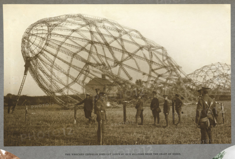 The wrecked Zeppelin brought down by our aviators near the coast of Essex, 1915 (1921). The skeleton of an airship which crashed in a field. From India Office Official Record Of The Great War, 1921.