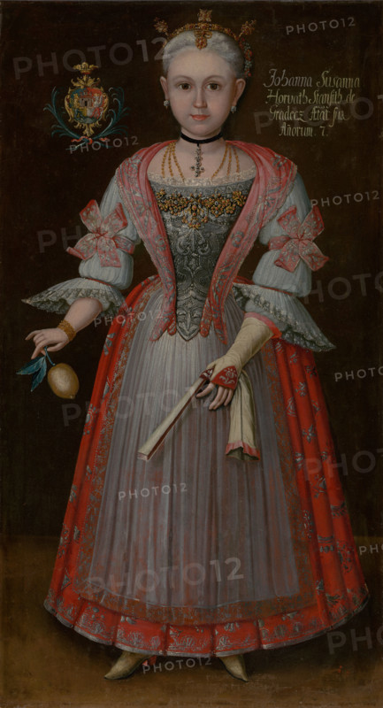 Johanna Zuzanna Horváthová aged seven, c1750. Young girl from a wealthy family, wearing a dress trimmed with lace and embroidered with silver thread. She holds a lemon and a fan.
