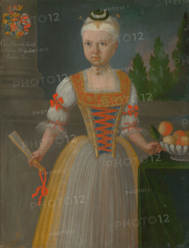Klára Horvath Stancic aged six, 1740. Young girl wearing gold hair decorations, a pearl necklace and bracelets, and a dress with ribbon- and lace-trimmed sleeves. She holds a fan in one hand and takes an orange from a fruit bowl.