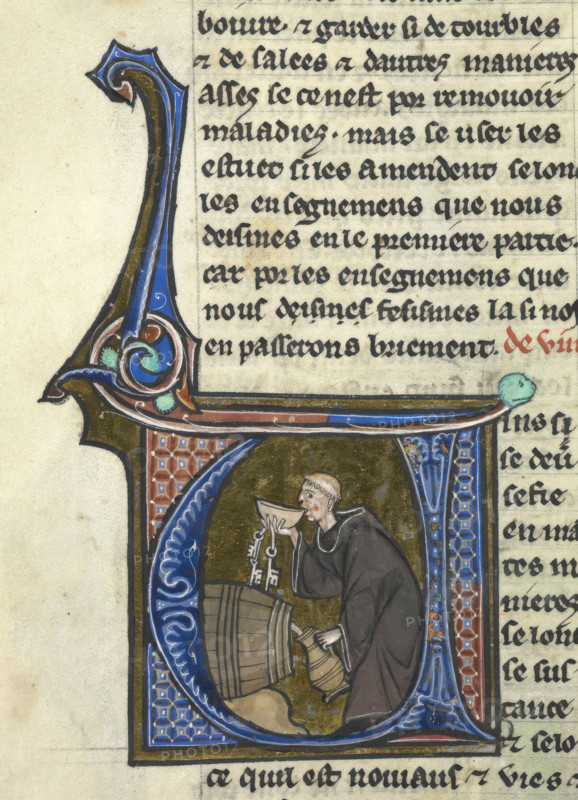 Initial 'V': a monk-cellarer tasting wine from a barrel whilst filling a jug, late 13th century.  Creator: Unknown.
