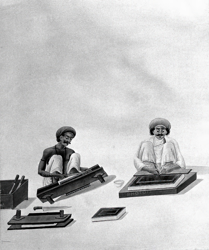 Two Indian bookbinders: one trimming page edges in a press, the other decorating a binding. Creator: Unknown.