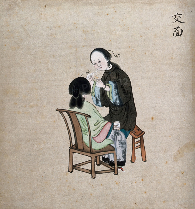 A standing woman preparing to remove facial hair from seated woman using a piece of string, 1800-99. Creator: Unknown.