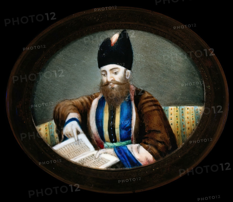 An Indian (?) man seated, reading a book. Creator: Unknown.