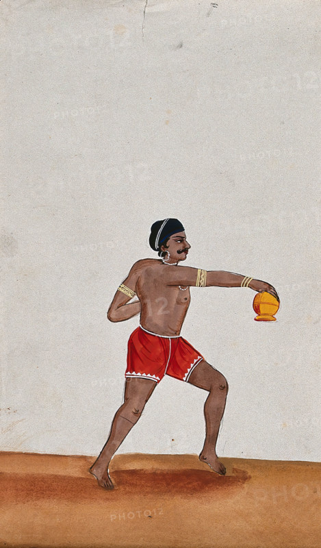 A street performer holding a small pot upside down, (between 1800 and 1899?). Creator: Unknown.