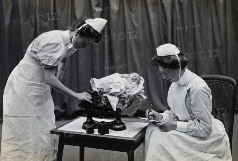 General Lying In Hospital, York Road, Lambeth: nurses weighing a baby, 1906 Creator: Unknown.