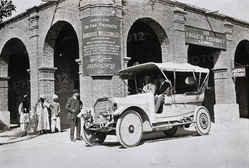 Two men in a car outside the Wellcome pharmaceutical depot in the Middle East, c1900s. Creator: Unknown.