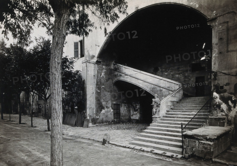 Hospital de la Santa Cruz, Barcelona: a staircase leading up to the men's department... Creator: Unknown.