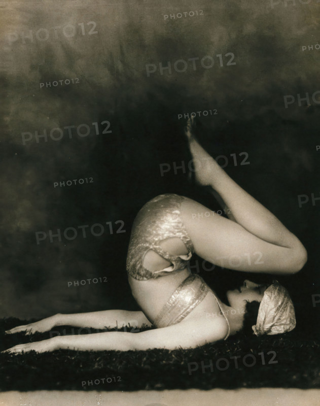 Marguerite Agniel posing with her back arched and feet in the air, wearing a two-piece cos..., 1929. Creator: Unknown.