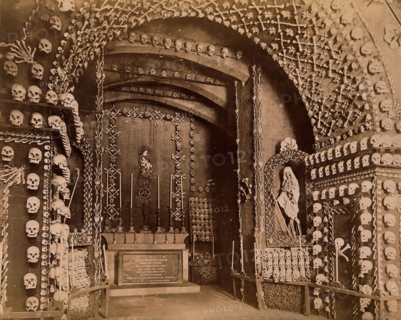An altar bearing a Latin inscription surrounded by an array of human skulls and bones and..., 1881. Creator: John Edmund Taylor.