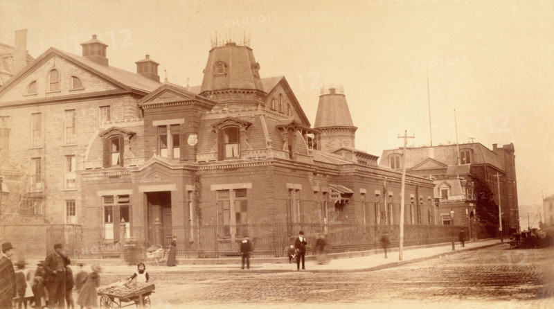 Bellevue Hospital, New York City: a street corner with hospital buildings and people, 1885-1898. Creator: Unknown.