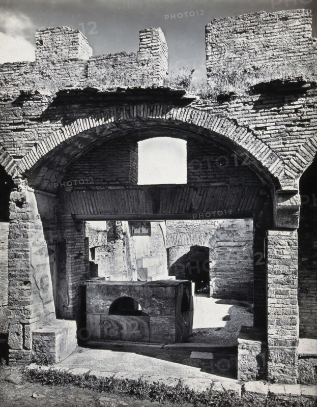 Partly ruined buildings in Ostia identified as a tavern or hot-food shop (thermopolium)..., 1920-9. Creator: Domenico Anderson.
