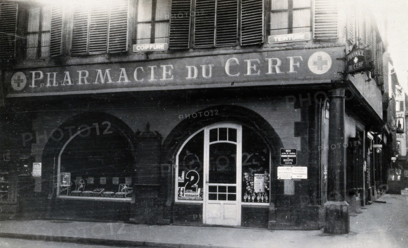 The front door of the Pharmacie du Cerf on the corner of the street, Strasbourg, c1900s.. Creator: Unknown.