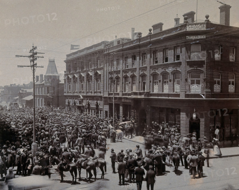 South Africa: a crowd of people gathered outside The Goldfields offices in Johannesburg, 1896. Creator: Unknown.
