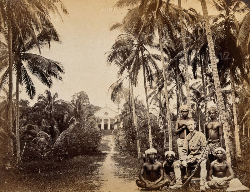 Singapore: a western hunter and native Malays with a background view of the Roman Catholic..., 1880. Creator: John Edmund Taylor.