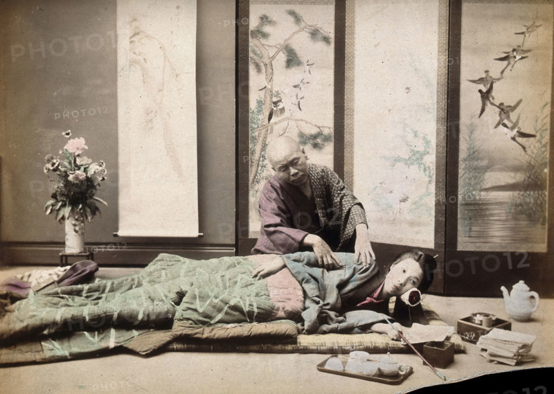 A Japanese woman being massaged by a blind Japanese masseur, c1890s. Creator: Unknown.