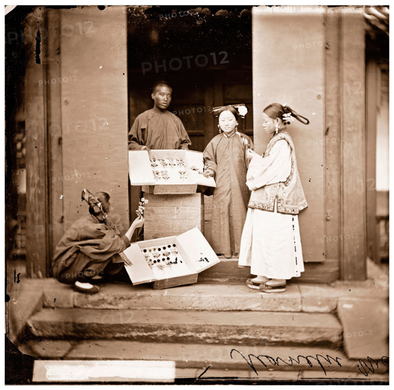 China: Manchu women buying flowers for their headdress, Beijing, 1869. Creator: John Thomson.