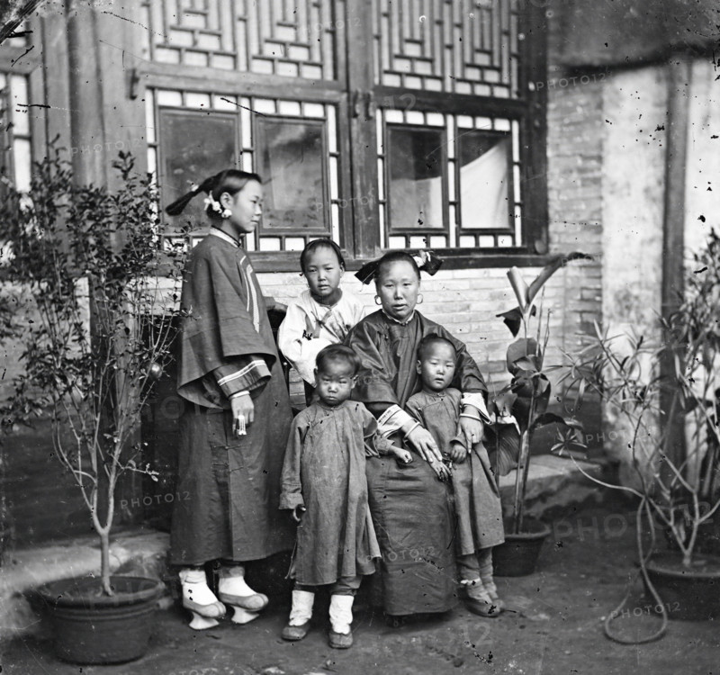 China: a Manchu lady with her daughter in-law and grandchildren, Beijing, 1869. Creator: John Thomson.