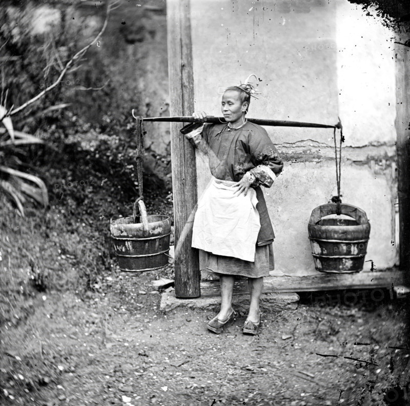 Foochow, Fukien province, China: a woman carrying buckets of night-soil, 1871. Creator: John Thomson.