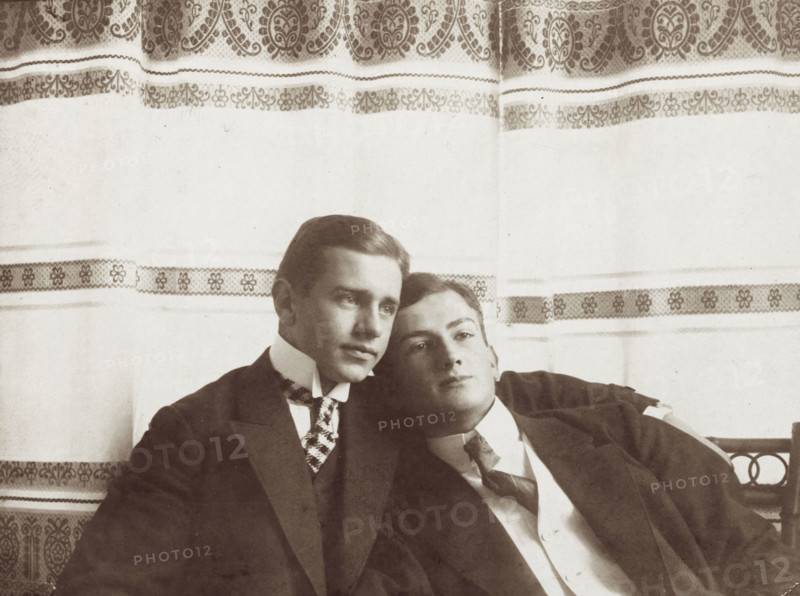 Two men resting close to one another, wearing formal attire, 1910. Creator: Unknown.