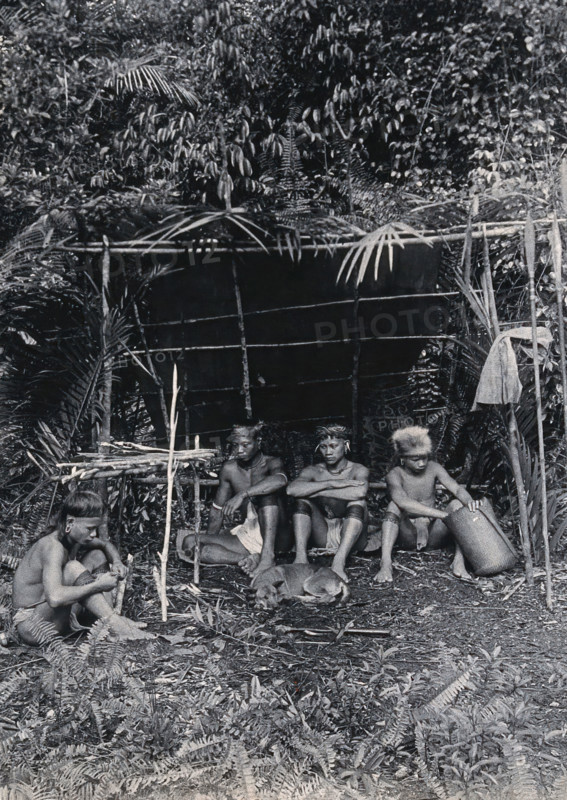 Sarawak: four Kayan hunters in their camp, c1900. Creator: Unknown.