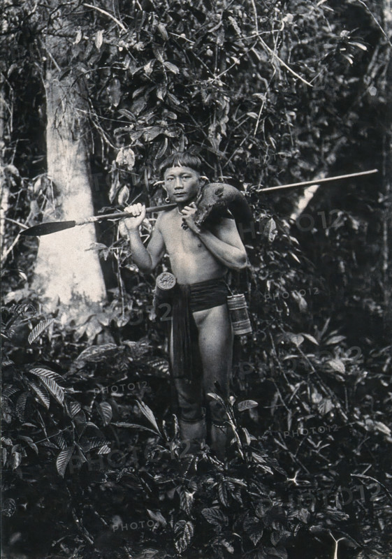 Sarawak: a Kenyah hunter with blowpipe and dead animal, c1900. Creator: Unknown.