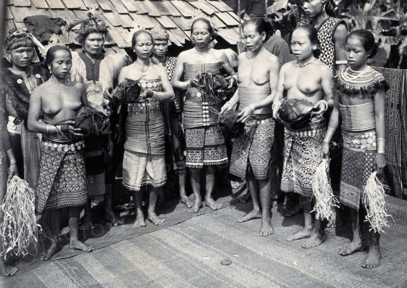 Sarawak: Sea Dayak men at a head feast, c1900. Creator: Unknown.