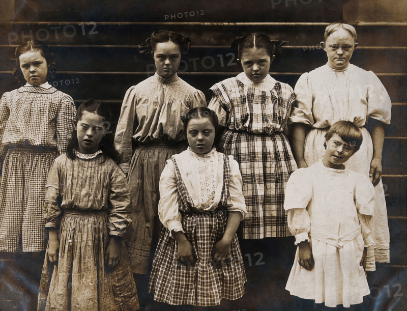 New York State Institute: a group of girls with Down's syndrome, standing on some steps, 1902. Creator: Unknown.