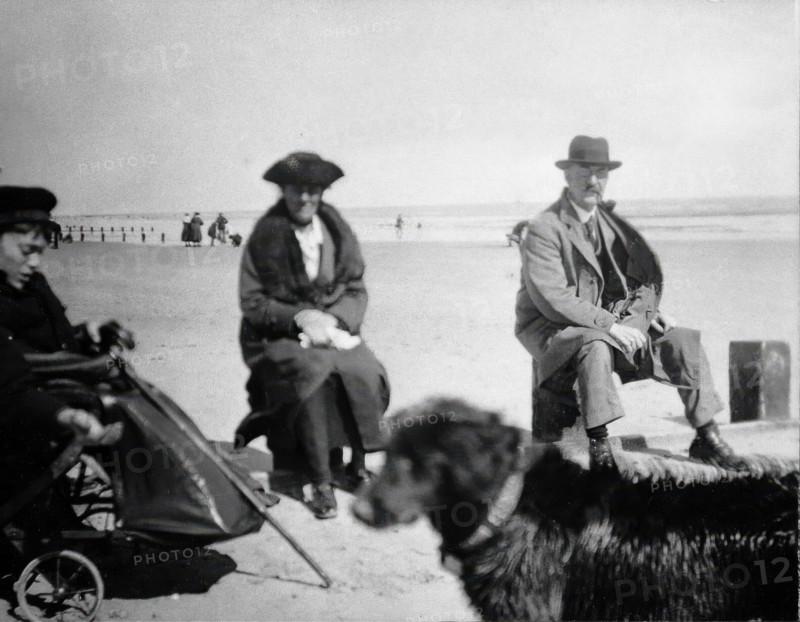 A physically disabled boy sitting in a wheelchair on a beach,  c1910/1925. Creator: Unknown.