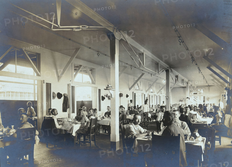 Panama Canal construction workers (American and European) dining in the Isthmian Canal..., c1910. Creator: Unknown.
