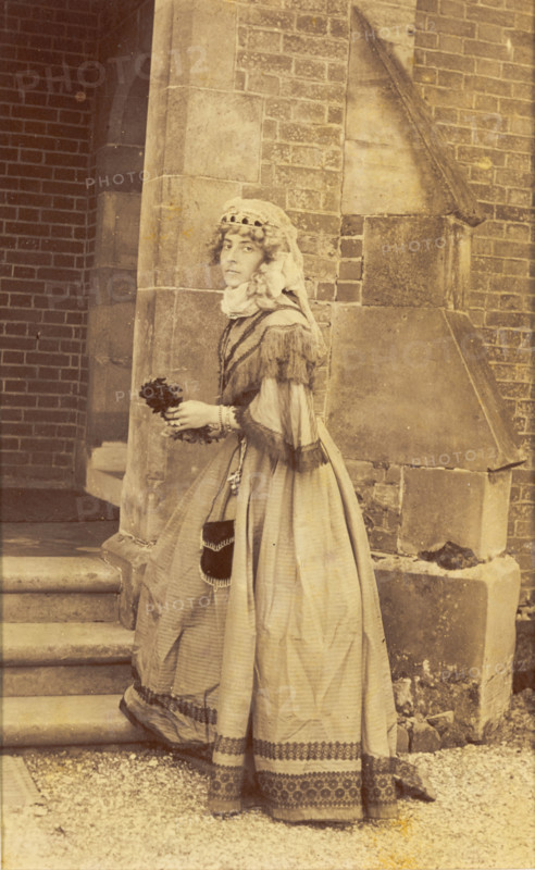 A man in drag posing in historical costume, (between 1890 and 1899?). Creator: Unknown.