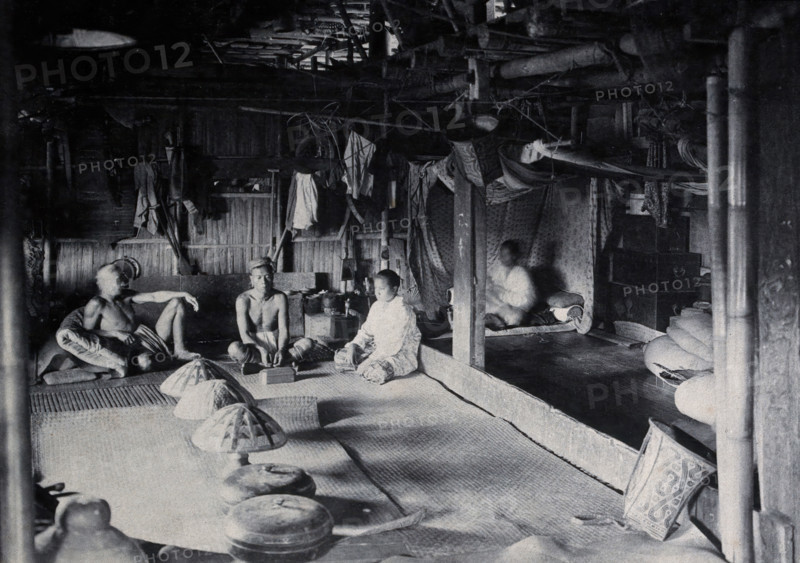 Sarawak: interior of a Kadayan tribal house, with a meal laid out, c1900. Creator: Unknown.