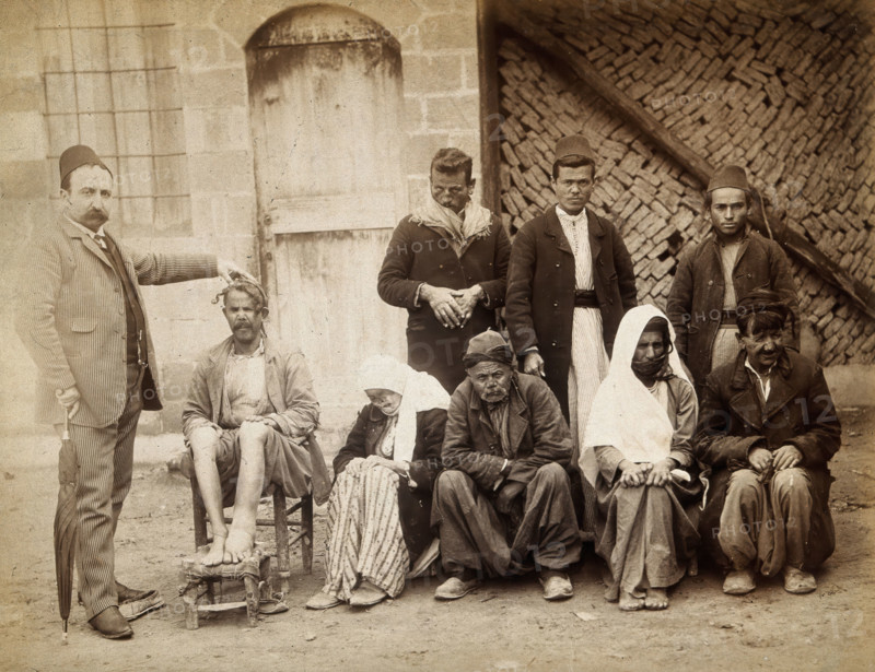 A group of people with leprosy in Jerusalem: a man in a striped suit..., c1890s. Creator: Unknown.