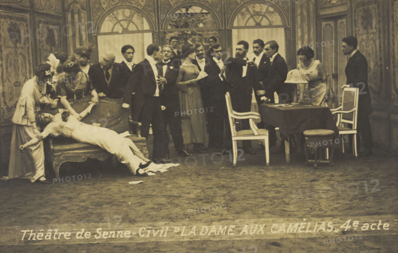 French or Belgian prisoners of war, some in drag, posing on stage during a crowded scene..., [1918?] Creator: Unknown.