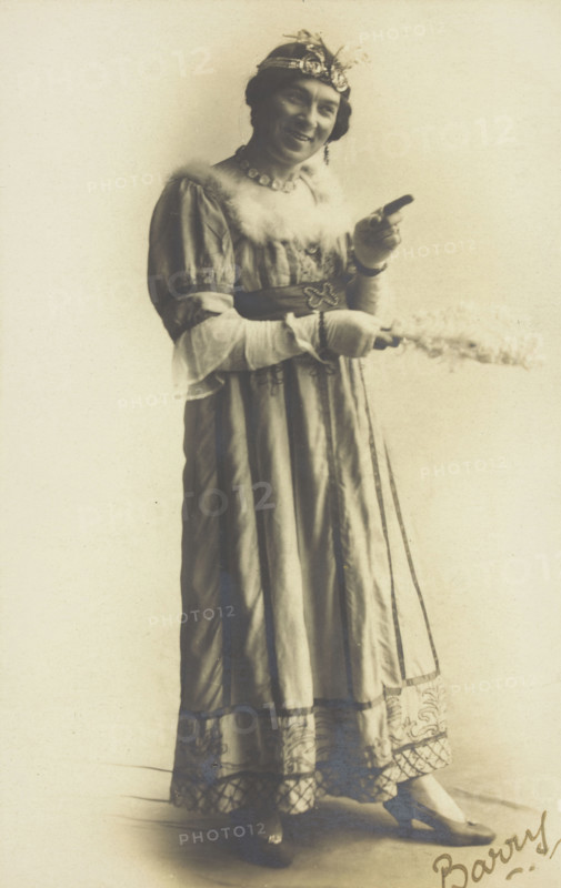 A man in drag, holding a feather, performing in the play 'A country girl', 1920. Creator: Unknown.