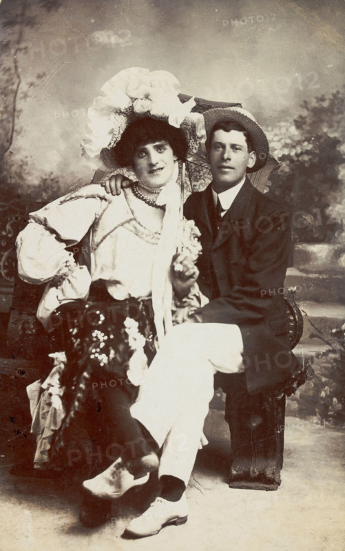 Two men, one in drag, sit together on a bench, (between 1900 and 1901?). Creator: Unknown.