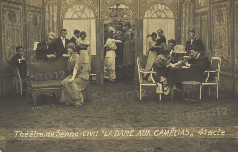 French or Belgian prisoners of war, some in drag, posing on stage during a crowded scene..., (1918?) Creator: Unknown.