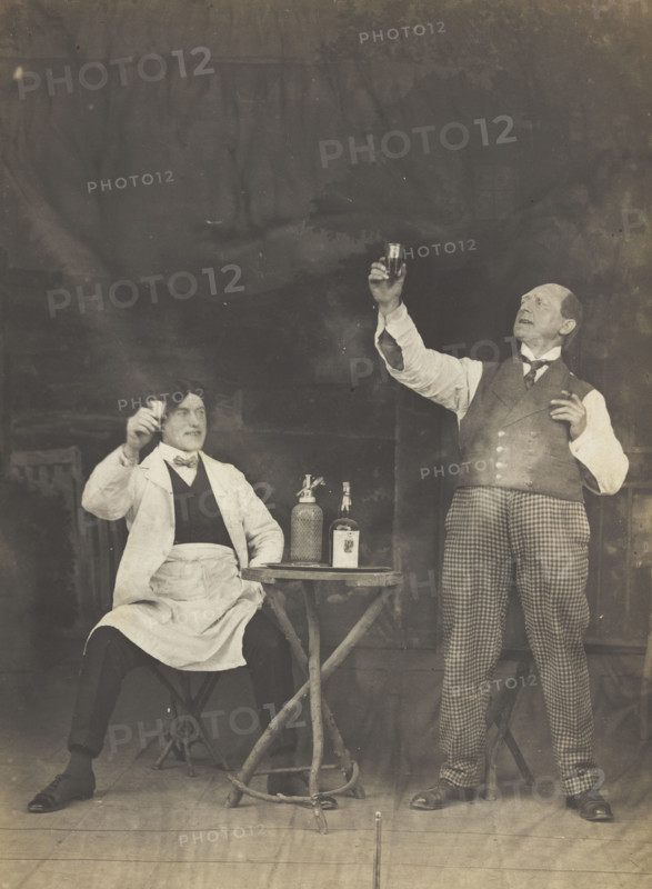 Two sailors pose on stage, holding up a drink, (between 1910 and 1919?). Creator: Unknown.