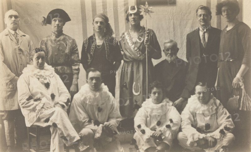 Concert party performers, some in drag, pose for a group portrait, (between 1910 and 1919?). Creator: Unknown.