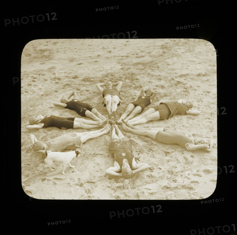 A group of female swimmers lying in a circle on the beach probably at Clacton-on-Sea..., 1920s.  Creator: Norman Kingsley Harrison.