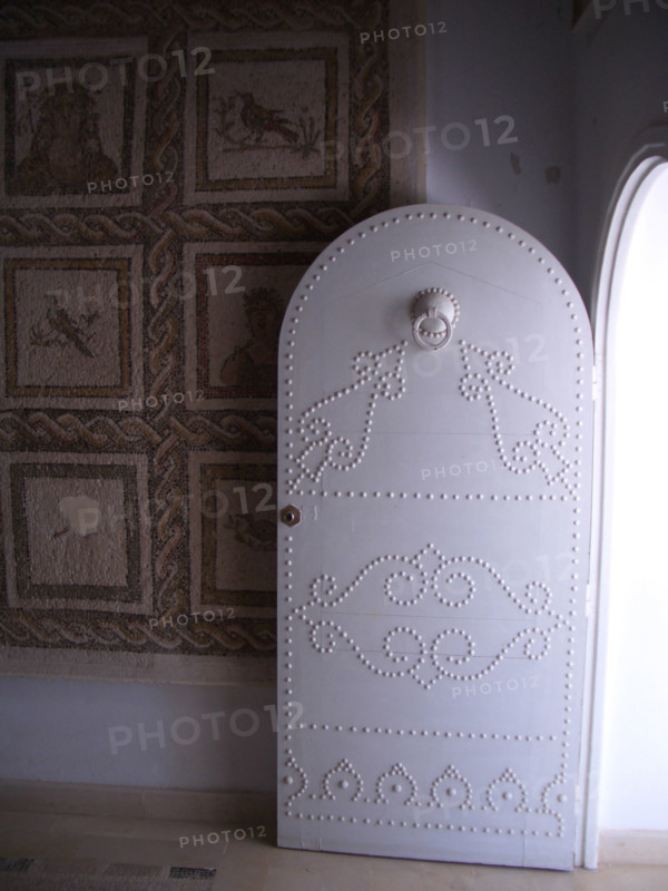 Studded door and mosaic, El Jem Museum, El Djem, Tunisia, 2009. Creator: Amanda Waite.