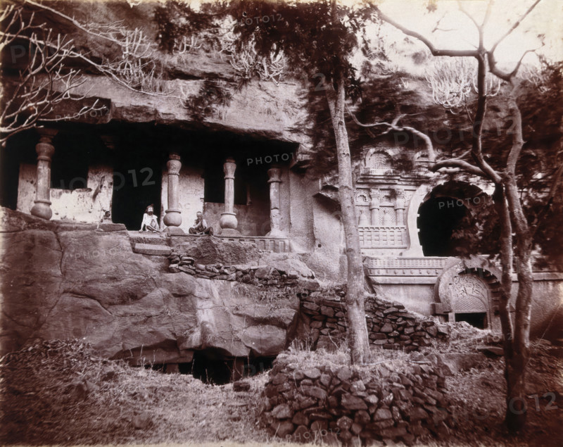 Two men sitting in a temple carved out of a rock face in Bombay at the time of the plague, 1896/1897 Creator: Unknown.